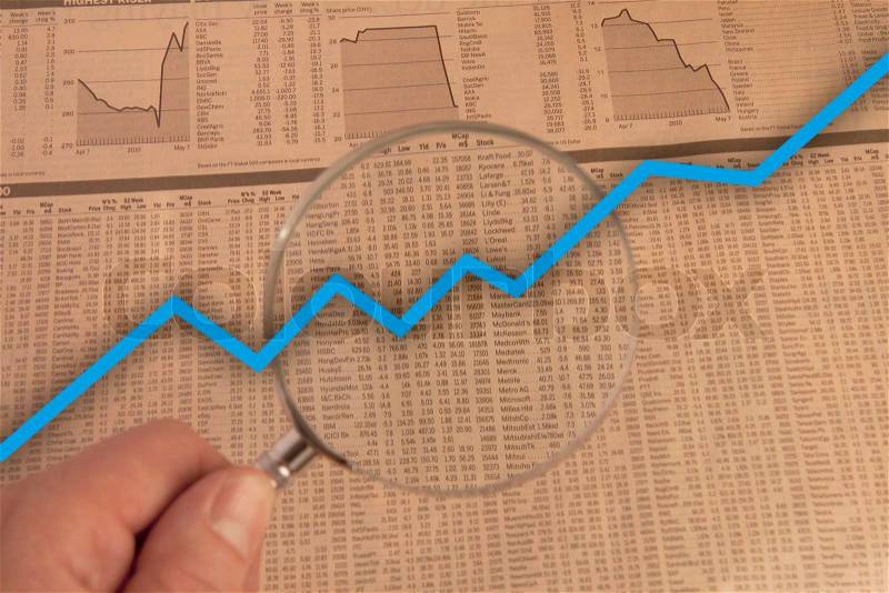 Hand with magnifying glass examine stock market with blue business arrow going up, stock photo