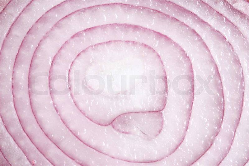 A red onion sliced in half and closed up, stock photo