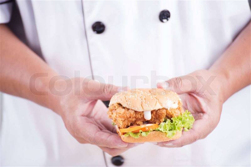 Chef presented a burger on the studio , stock photo