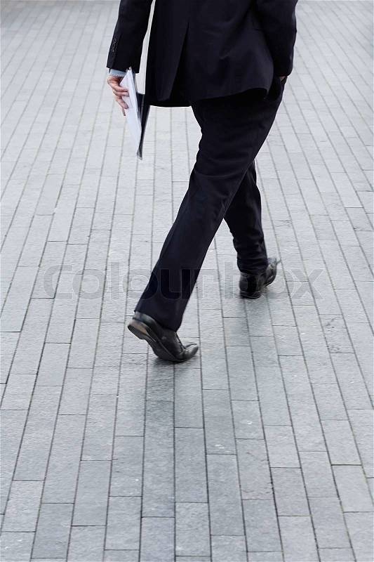 A business man walking outdoor, stock photo