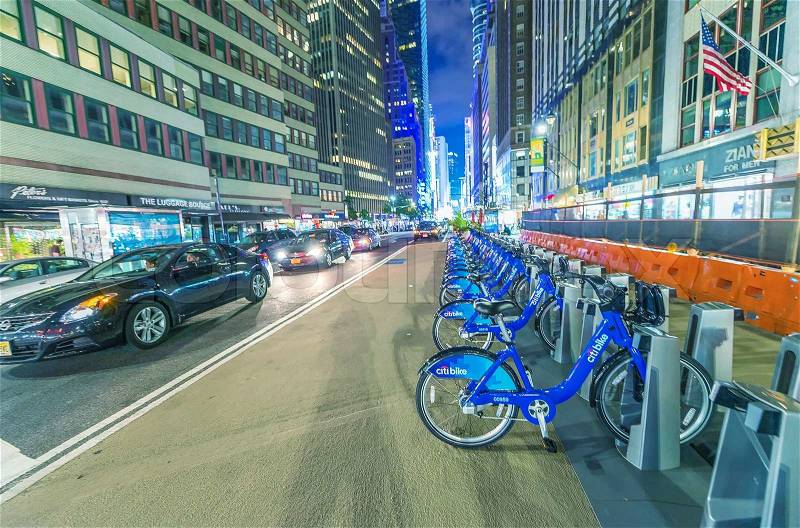 NEW YORK CITY - JUNE 8, 2013: NYC bike share system along city streets at night, Manhattan, New York City, USA, stock photo