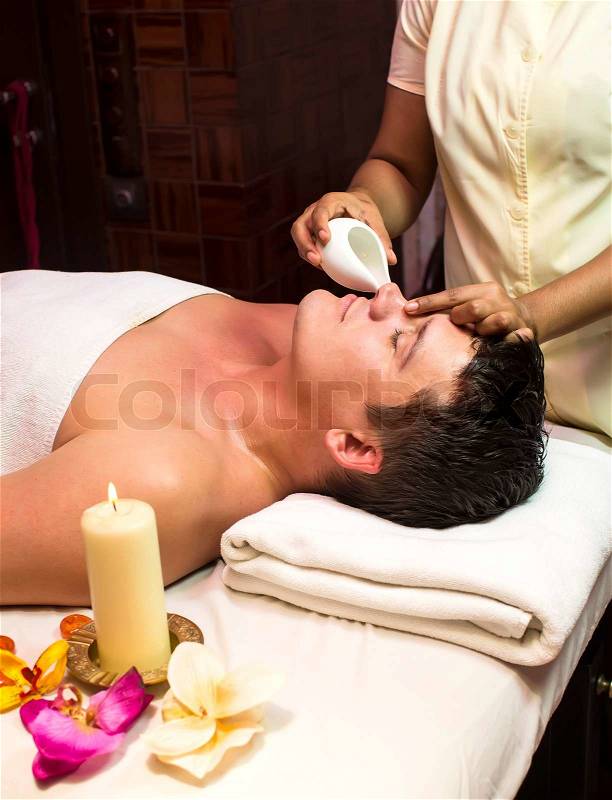 Man engaged in Ayurvedic spa treatment, stock photo