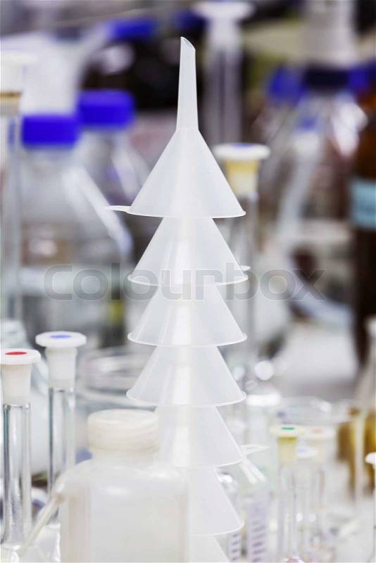 Close up stacks of white color plastic funnels in laboratory, stock photo