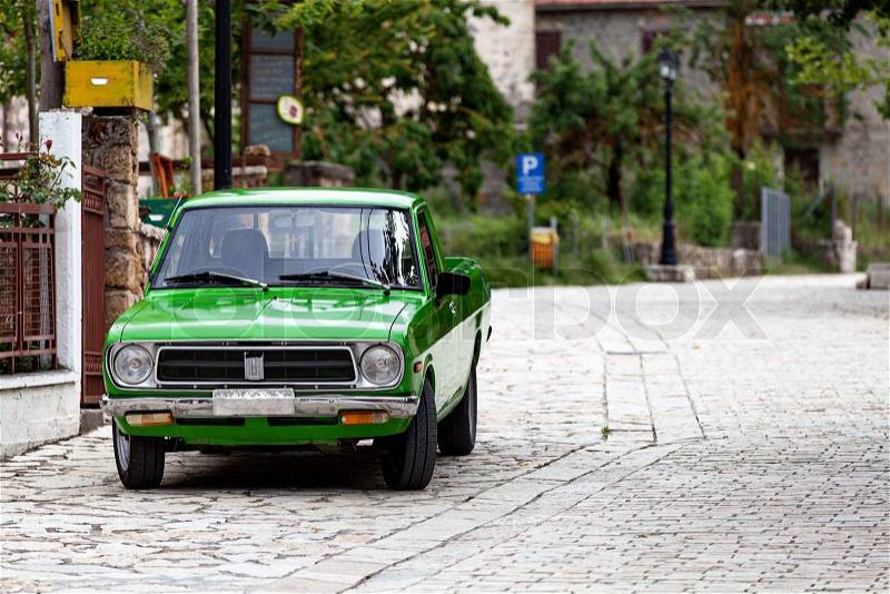Old green pickup car on the street, stock photo