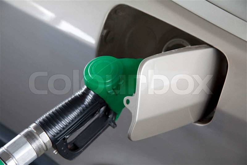 Car at gas pump filling up with petrol, stock photo