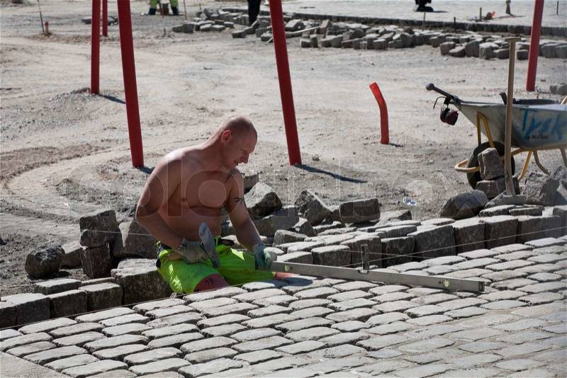 Pavers working hard in the heat, stock photo