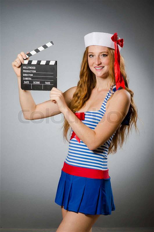 Young woman sailor with movie board, stock photo