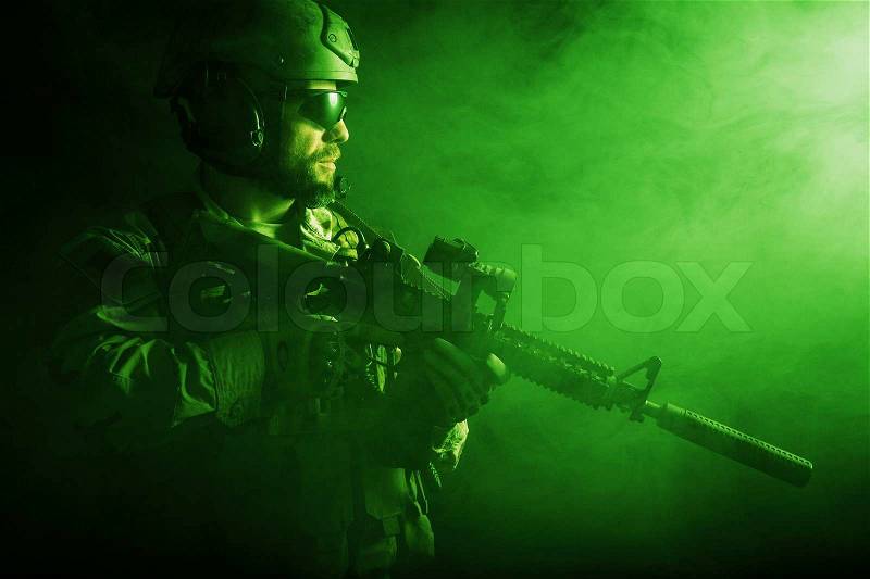 Bearded special forces soldier on dark background, stock photo