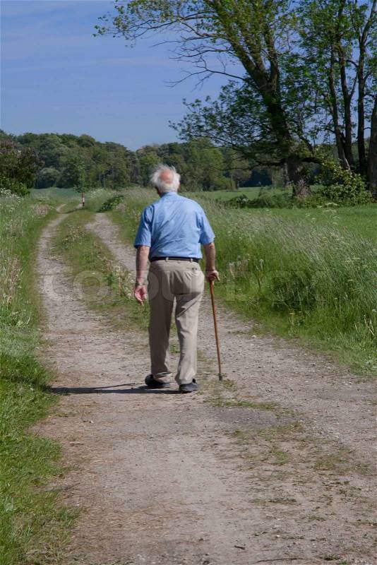 Old man with walking stick, stock photo
