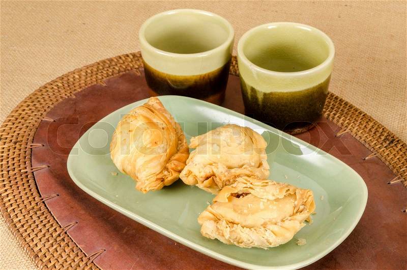 Image of curry puff in green ceramic dish on brown sack background, stock photo