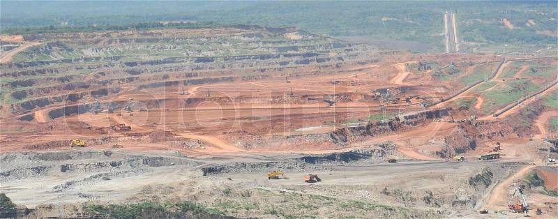Open pit mining of coal and working machinery, stock photo
