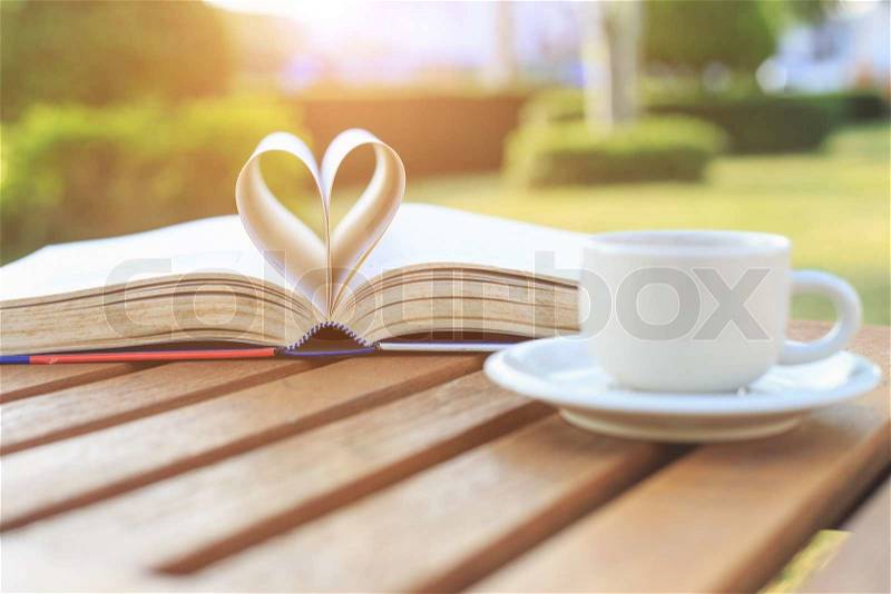Coffee cup and book on the table in the morning, stock photo