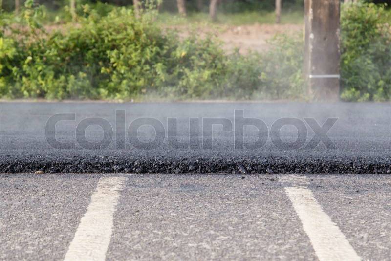Road roller and asphalt paving machine at construction site, stock photo