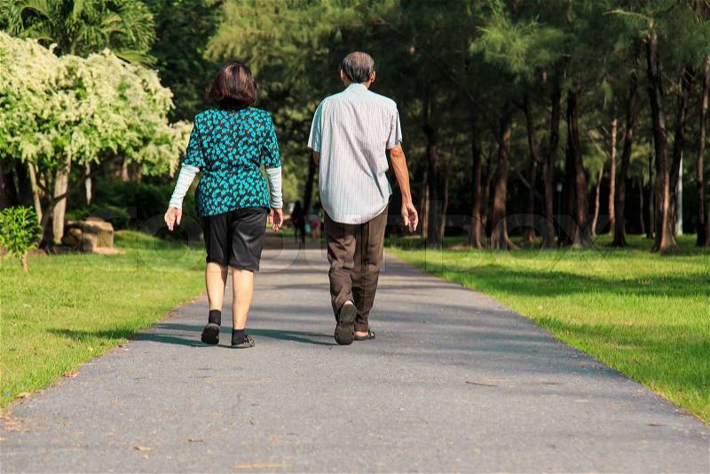 Old people walking in the park, stock photo