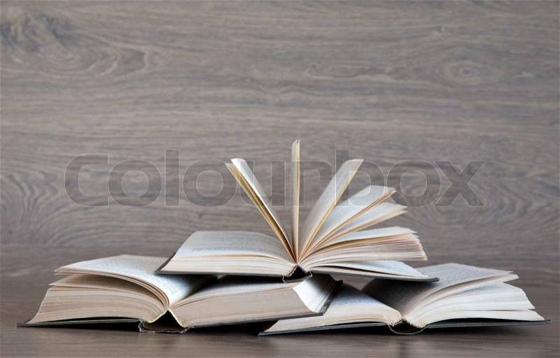 Books on wooden deck tabletop, stock photo