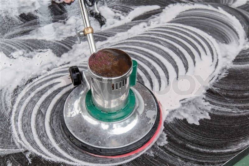 Thai people cleaning black granite floor with machine and chemical, stock photo