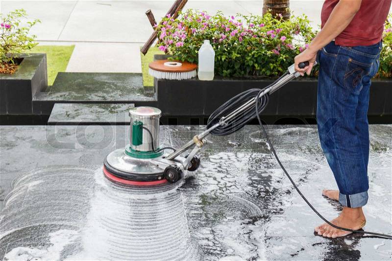 Thai people cleaning black granite floor with machine and chemical, stock photo