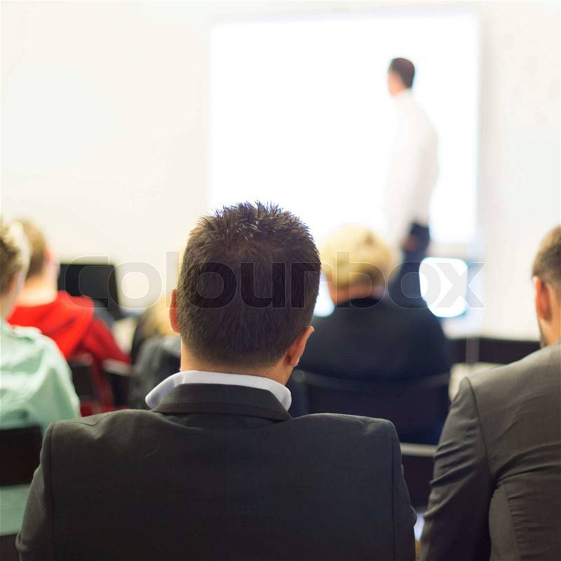 Speaker at business workshop and presentation. Audience at the conference room, stock photo