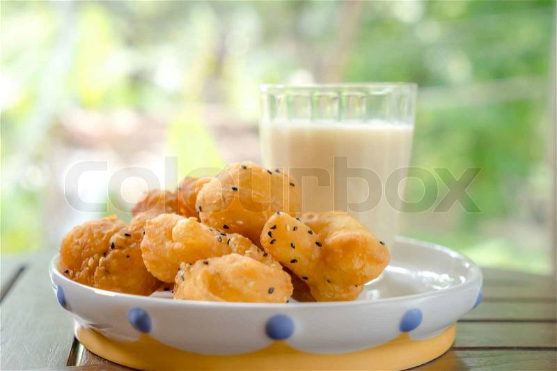 Soybean milk with deep-fried dough stick and black sesame seeds, stock photo