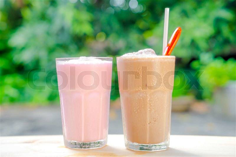 Milk tea smoothie and strawberry smoothie. on wooden table, stock photo
