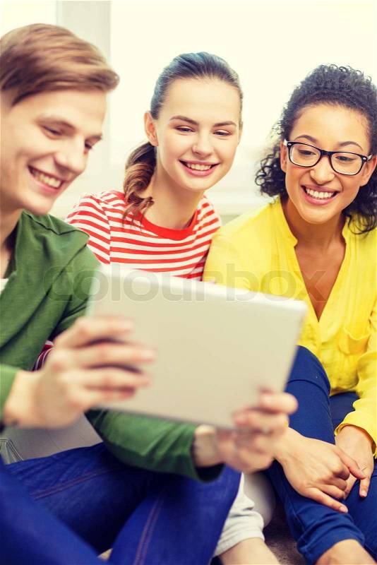 Education and technology concept - smiling students with tablet pc computer at home, stock photo