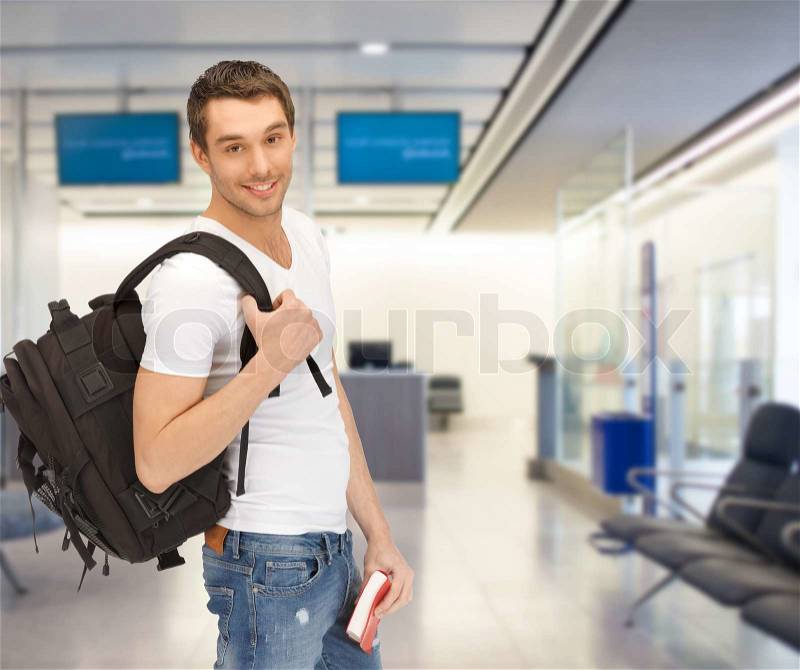 Travel, education, tourism and people - smiling student with backpack and book at airport, stock photo