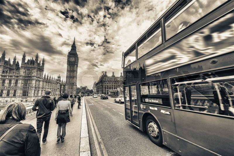 Double Decker bus crossing crowded Westminster Bridge, stock photo
