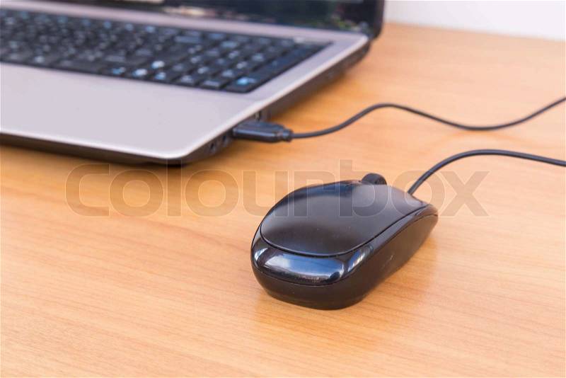 USB mouse cable on laptop, stock photo