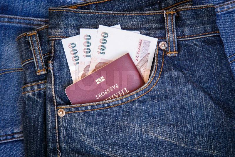 Thailand Passport and money in denim jeans pocket, stock photo