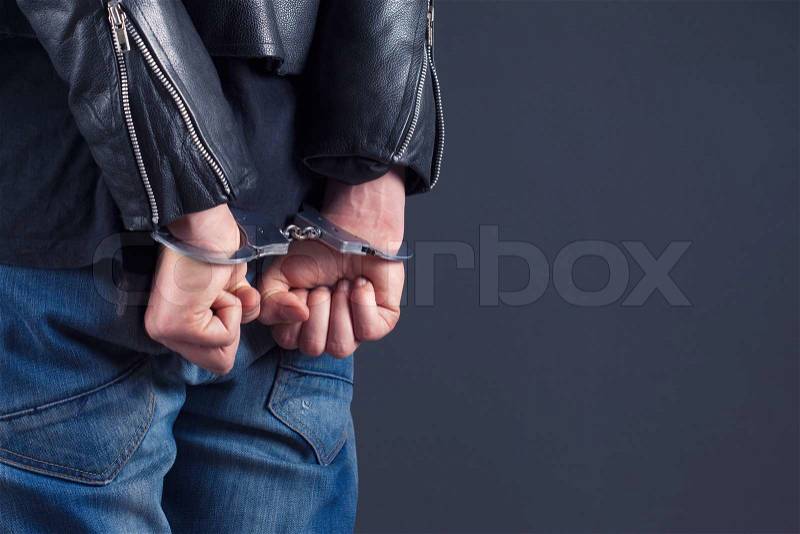 Man hands in handcuffs , stock photo