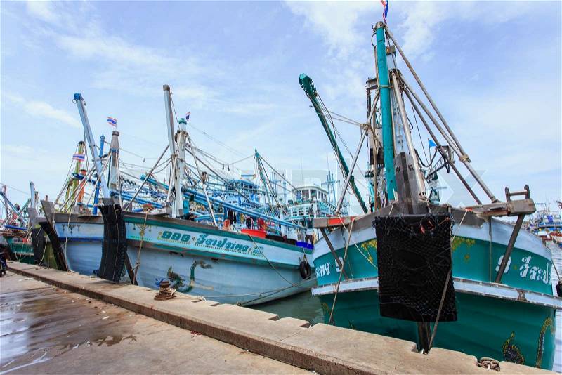PHUKET - JULY 27 : Fishing boats stand in the harbor To transport fish from the boat to the market which 100% of labor on boat is Burmese on July 27, 2014 in Phuket, Thailand, stock photo