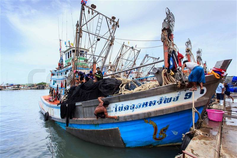 PHUKET - JULY 27 : Fishing boats stand in the harbor To transport fish from the boat to the market which 100% of labor on boat is Burmese on July 27, 2014 in Phuket, Thailand, stock photo
