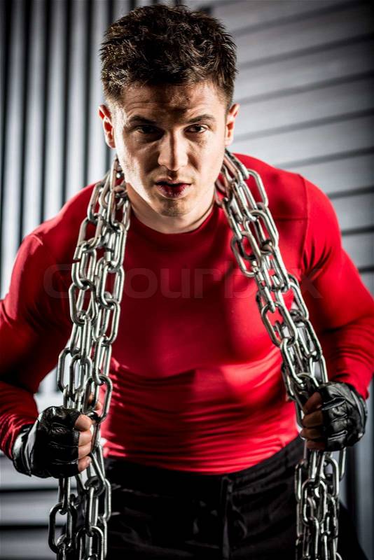 Handsome and muscular young guy with chain, stock photo
