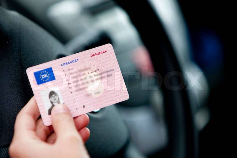 A female danish driver holding a driver\'s license, stock photo