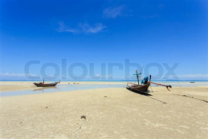 Traditional Thai boat or long tail boat stand at the beach, stock photo