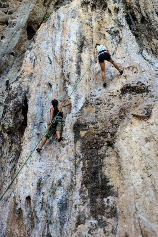 Tourist climbing on mountain, stock photo