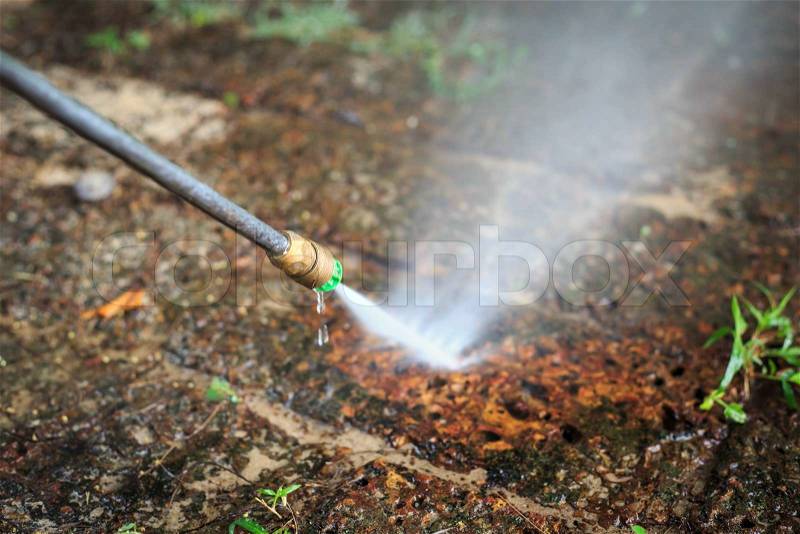 Stone floor cleaning with high pressure water jet, stock photo