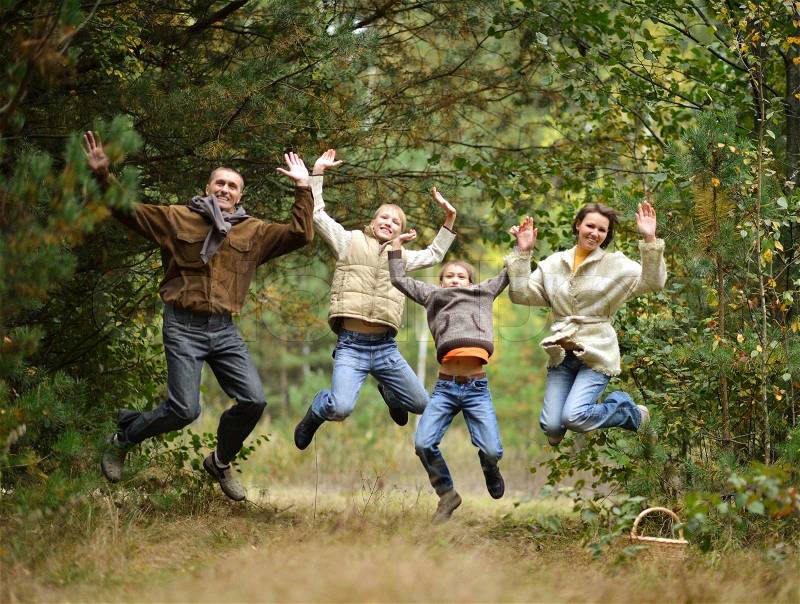Portrait of happy family in autumn forest, stock photo