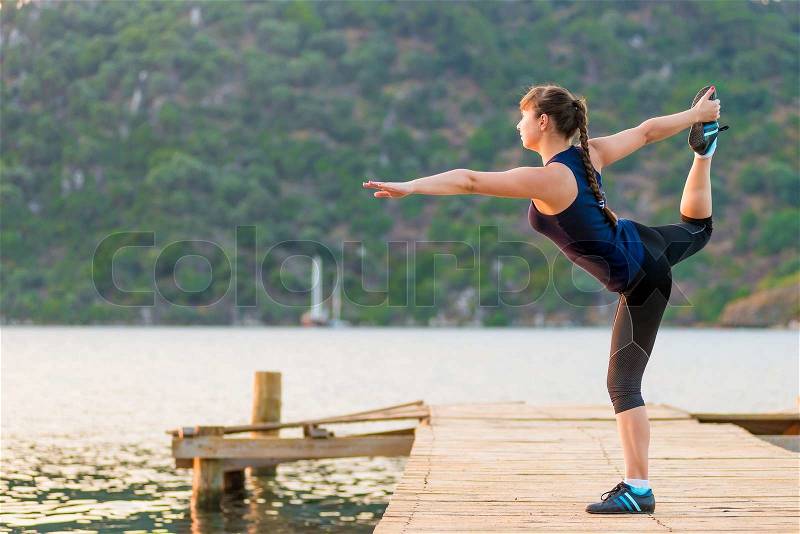 Morning stretching outdoors at the sea, stock photo