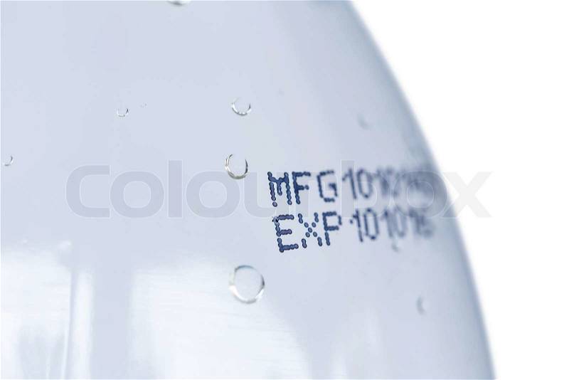 Close up expiration date on plastic bottle isolated on white background, stock photo