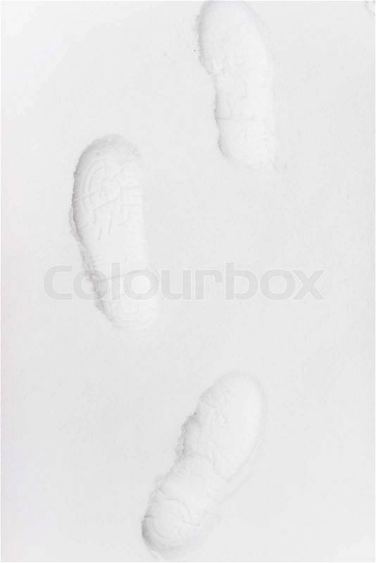 Human footprints in the snow under sunlight close-up view, stock photo
