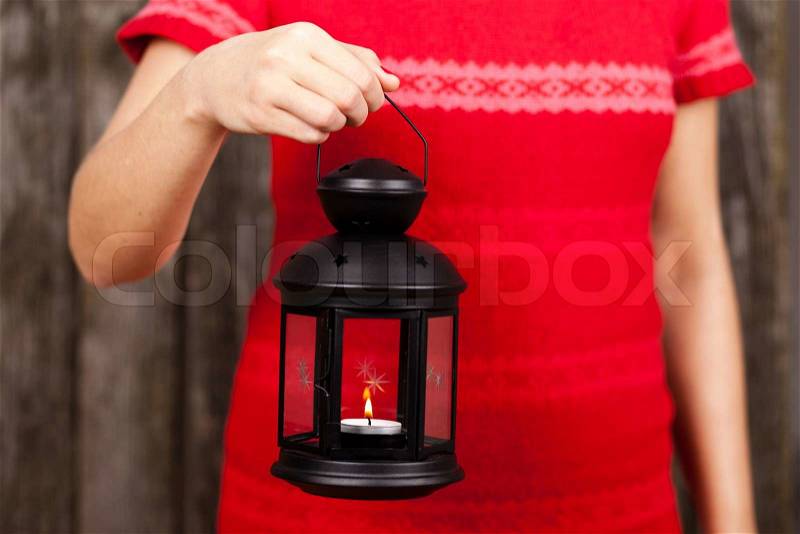 Female hands holding a lantern, stock photo