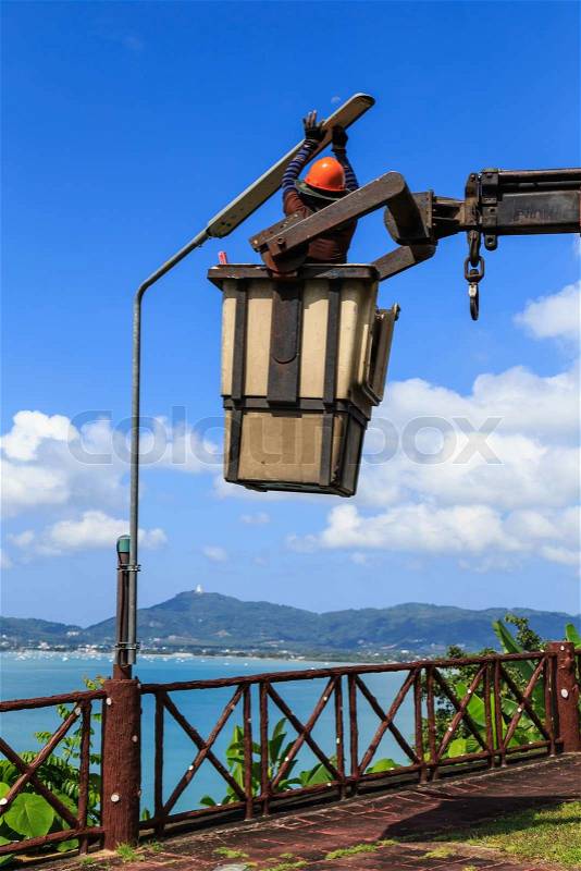 Electrician Man changing lamp, stock photo