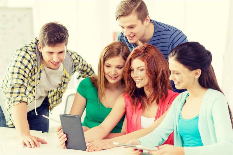 Education, technology and internet concept - smiling students with tablet pc computer at school, stock photo