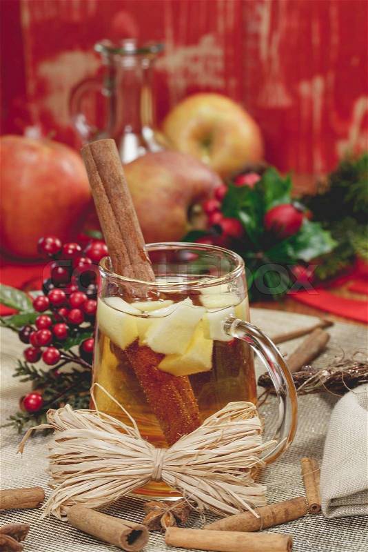 Glass of mulled apple cider with orange and spices. Winter drink, stock photo