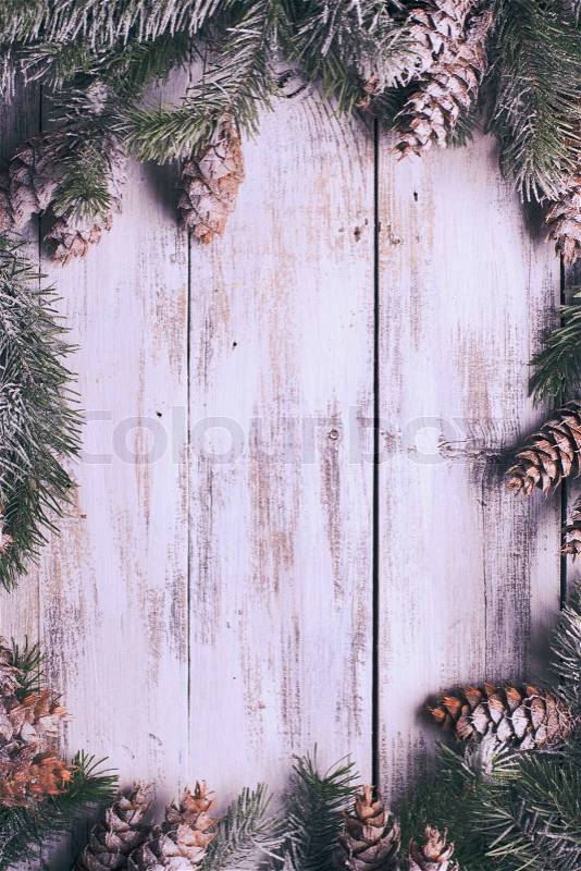 White shabby Christmas border with snow covered pinecones, stock photo