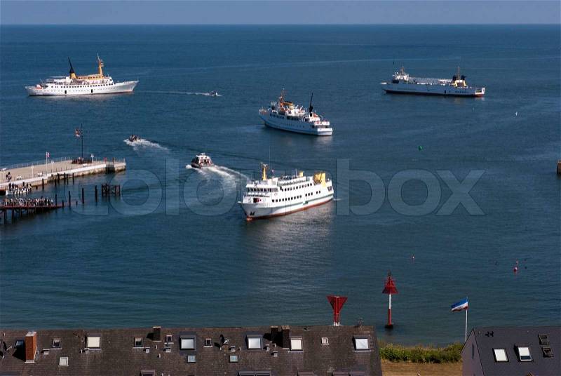 Ferry service close to Helgoland. Small boats carry passengers to bigger boats, stock photo