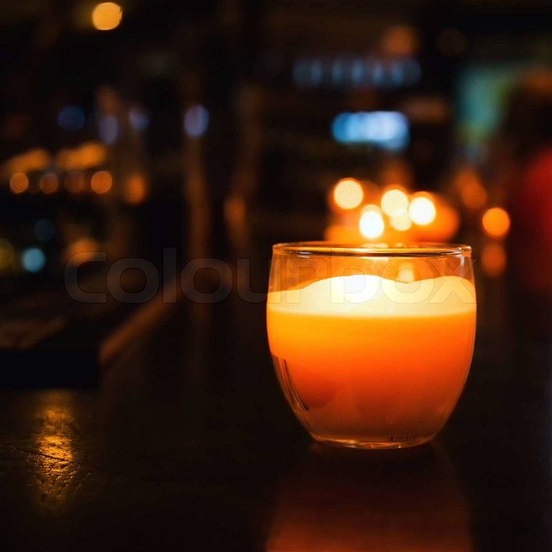Candle in a glass. Photos of cafe or restaurant reception. Selective focus with bokeh, stock photo