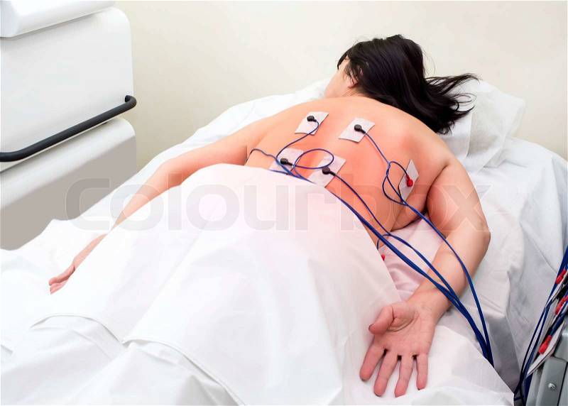 Woman in massage clinic makes electropulse, stock photo