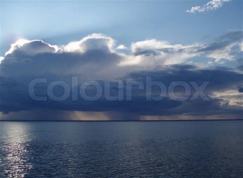 Rain and clouds on the horizon of the sea seen from a ship, stock photo